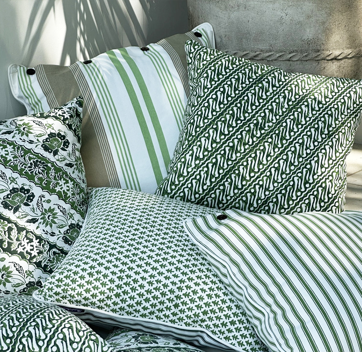 Infuse your space with the artisanal beauty of the Jawa Cushion. Features a parrot green batik design on lightweight canvas. Discover yours now!