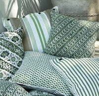Infuse your space with the artisanal beauty of the Jawa Cushion. Features a parrot green batik design on lightweight canvas. Discover yours now!